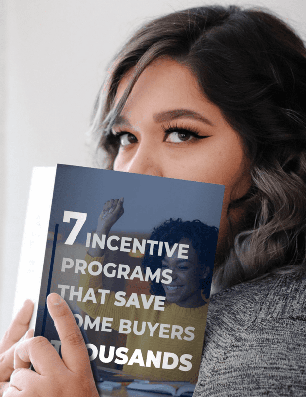 Woman holding a book about incentive programs for home buyers.