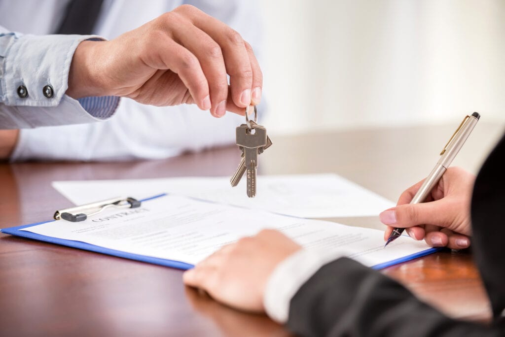 A client sitting down with a REALTOR to go through the contracts on a home purchase