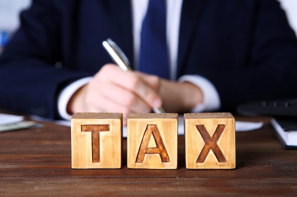 wooden cubes with word tax on table