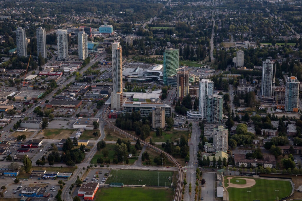 A bustling urban neighborhood in Surrey, showcasing high-rise buildings, busy streets, and a vibrant cityscape, reflecting the energetic and cosmopolitan nature of the area.