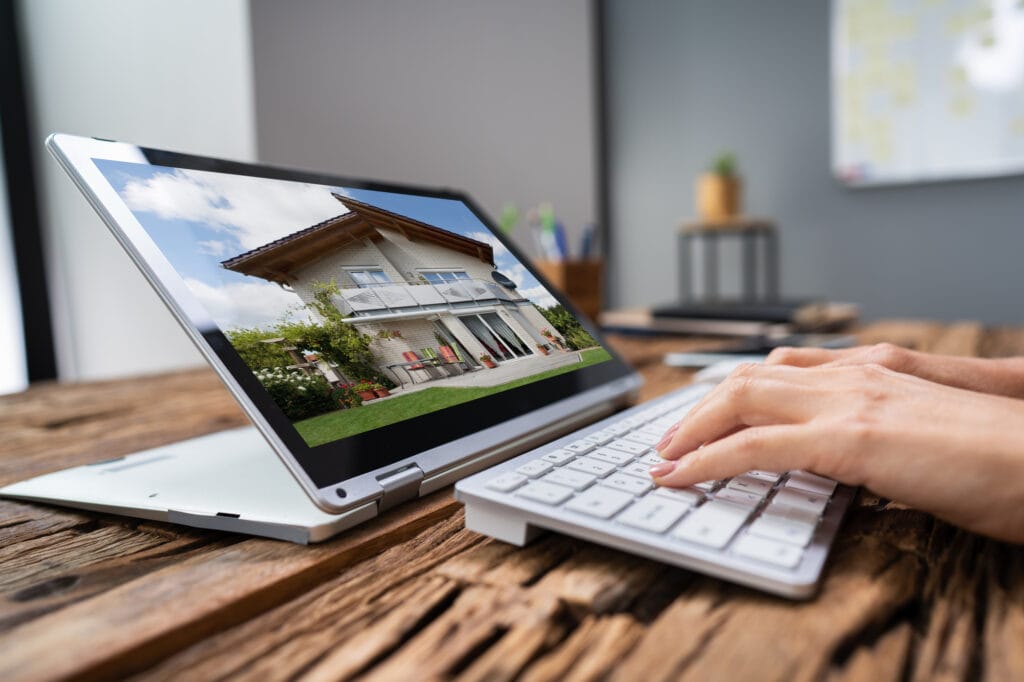 woman selecting new house on laptop