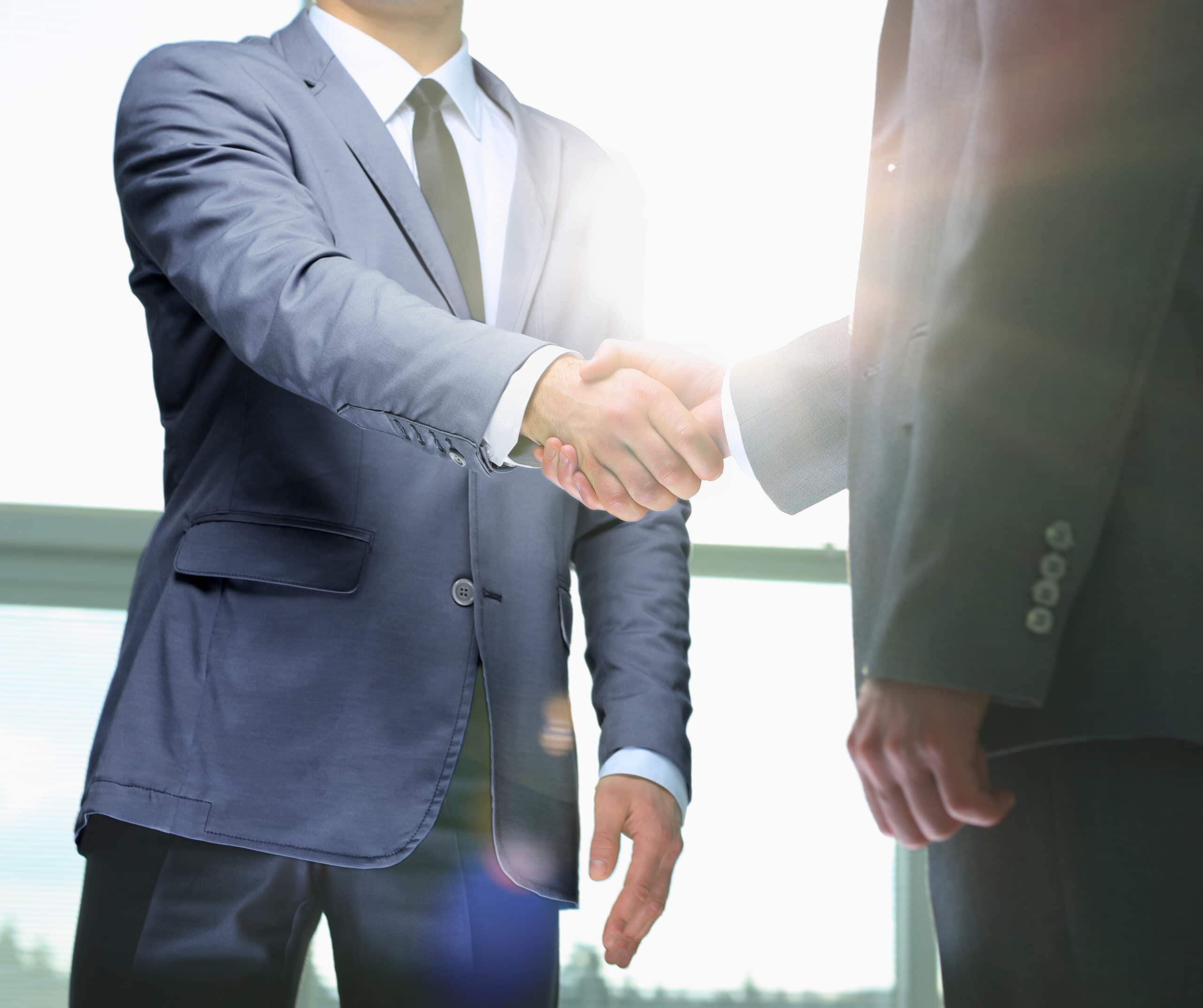 business handshake. two businessman shaking hands in the office.