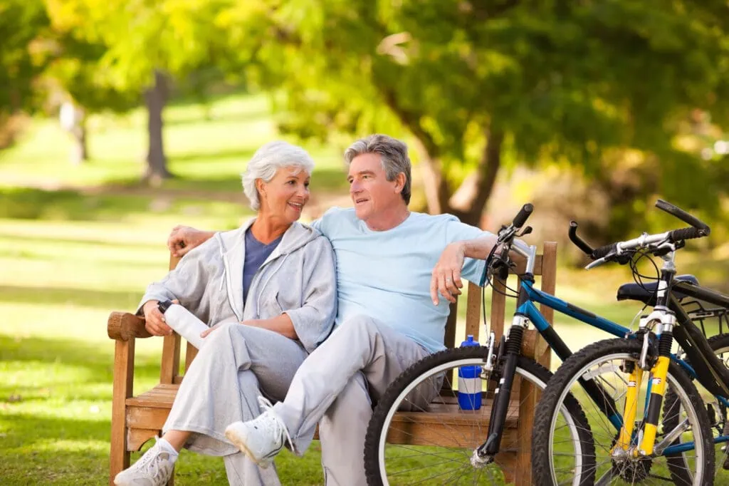 elderly couple with their bikes