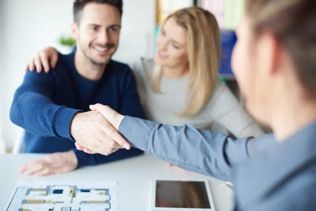 man shaking hands with real estate agent